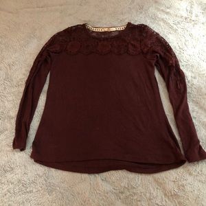 A long-sleeved maroon Rewind shirt